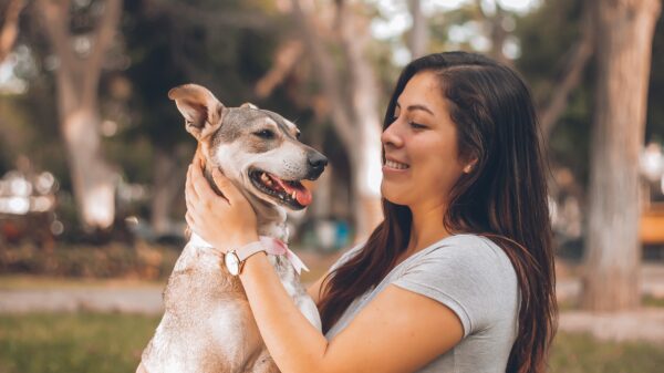 Picture showing a lady holding a dog