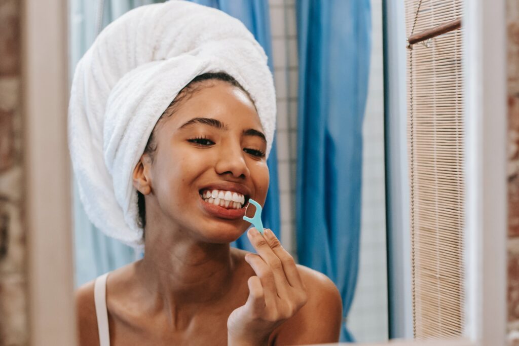 Picture showing a lady using a dental floss
