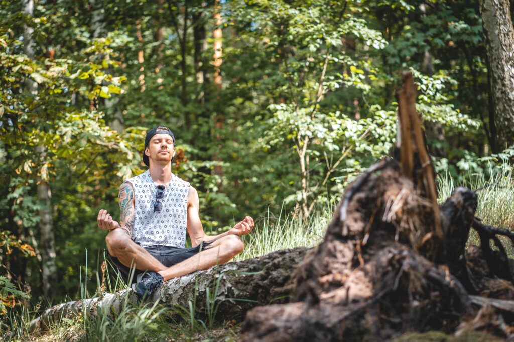 Picture showing a guy meditating.